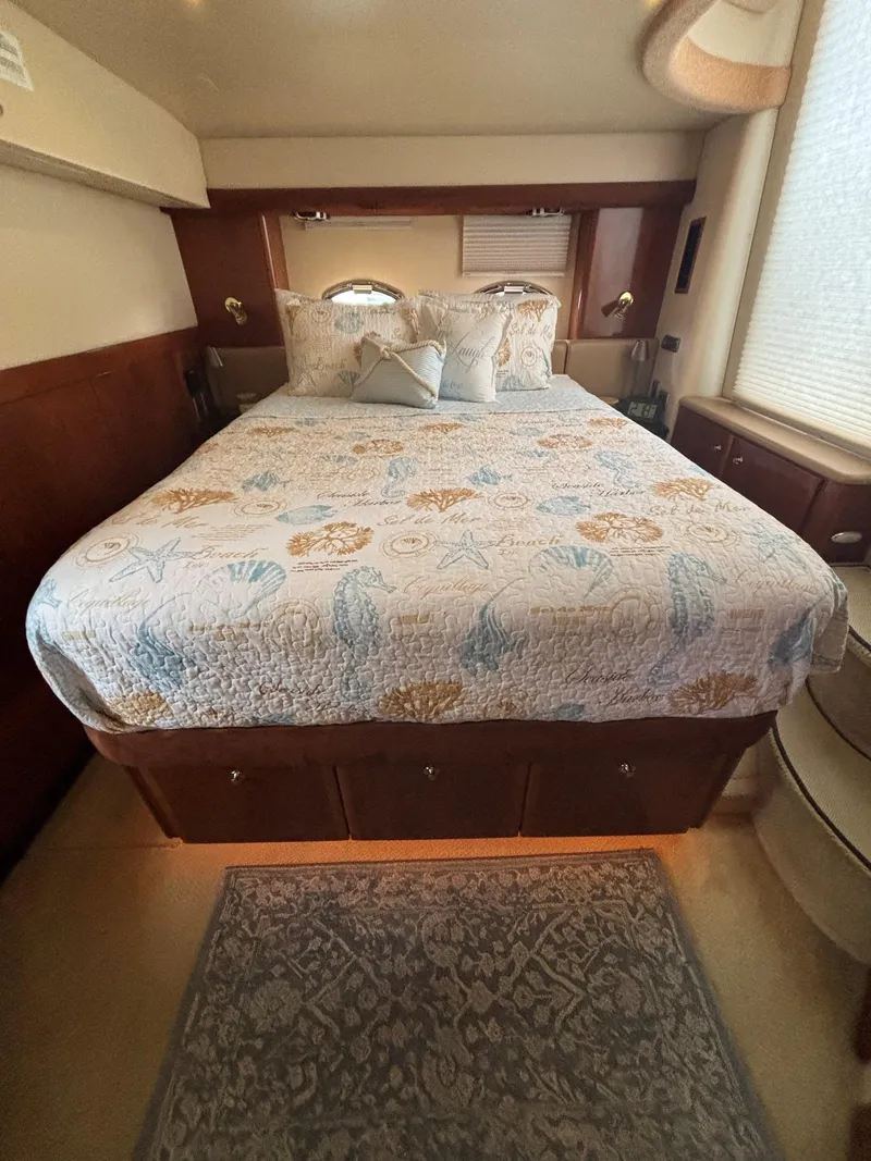 Slide: The Image of 2007 Meridian 459 Motoryacht bedroom with patterned bedding and elegant decor. - 12