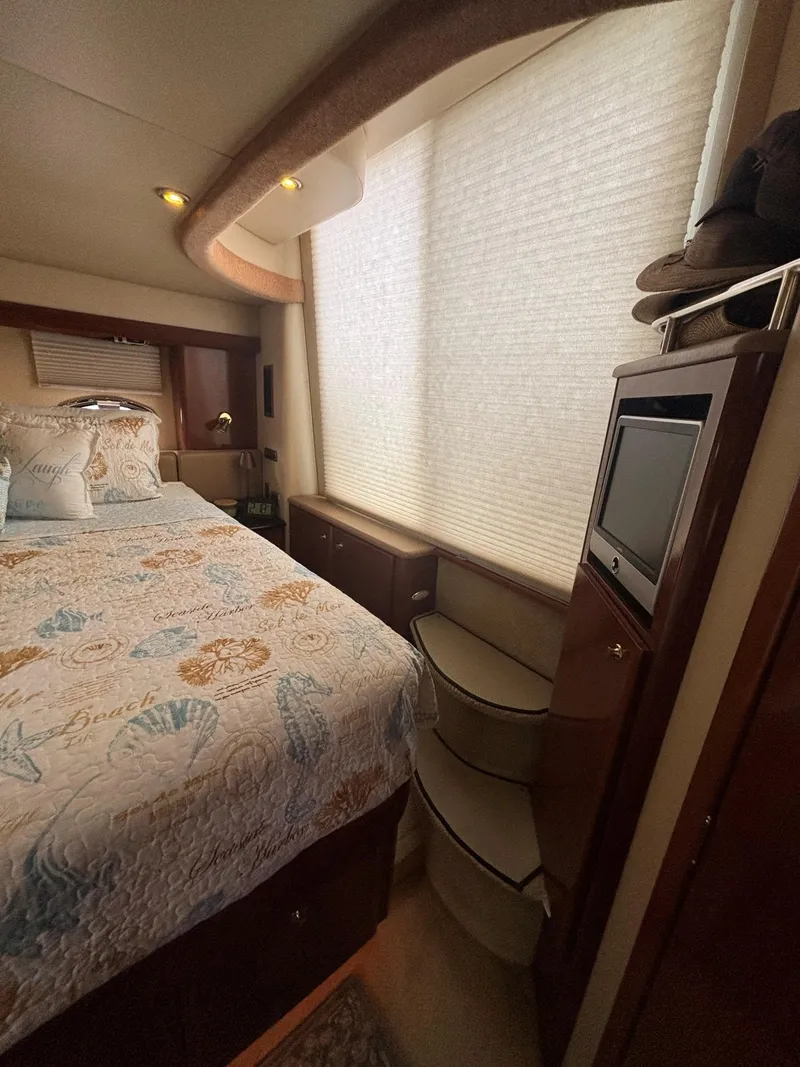 Slide: The Image of Interior of 2007 Meridian 459 Motoryacht bedroom with bed, TV, and stairs. - 14