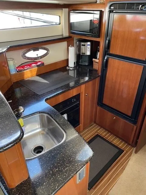 Slide: The Image of 2007 Meridian 459 Motoryacht kitchen with sink, fridge, and microwave. - 21