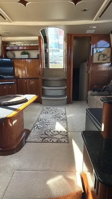 Slide: The Image of Interior of 2007 Meridian 459 Motoryacht with elegant wood finishes and plush carpeting. - 24