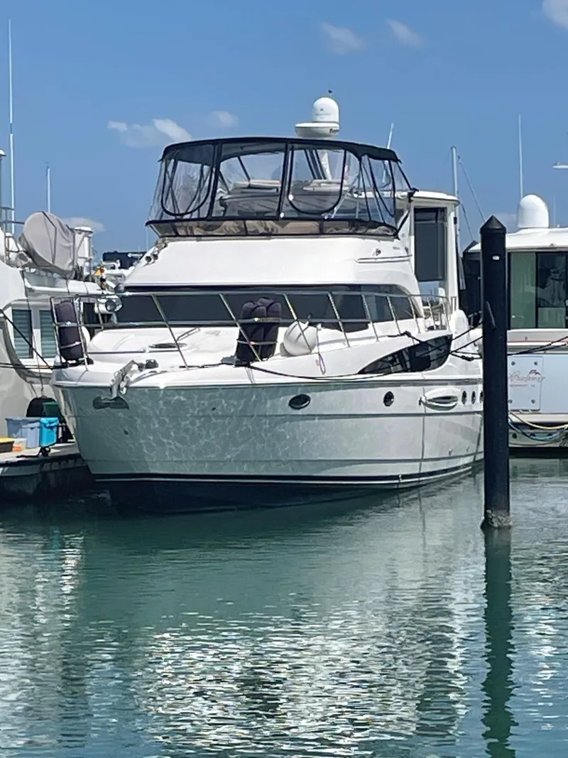 Slide: The Image of 2007 Meridian 459 Motoryacht docked in a marina under clear blue skies. - 3