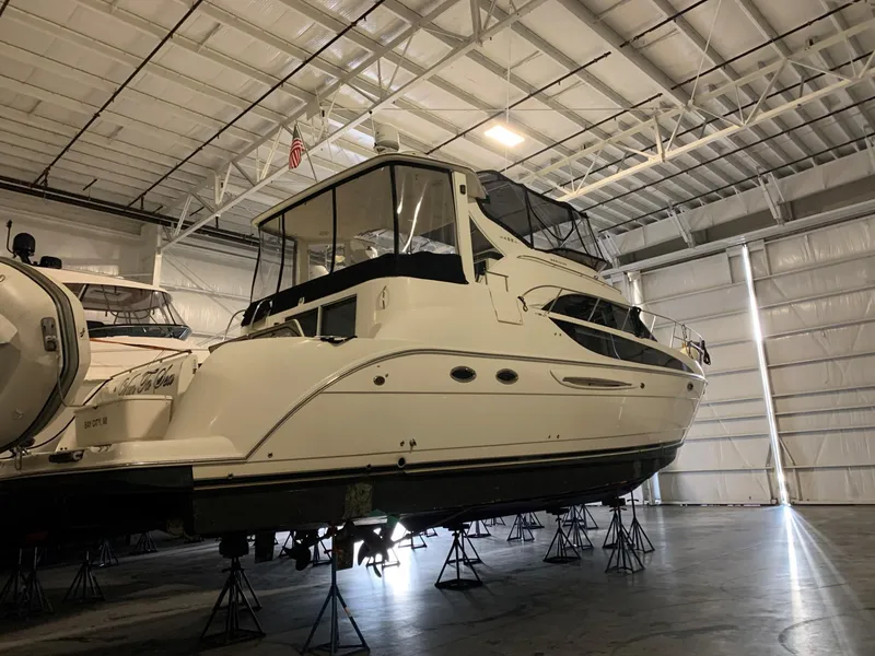 Slide: The Image of 2007 Meridian 459 Motoryacht in storage, elevated on stands inside a spacious warehouse. - 39