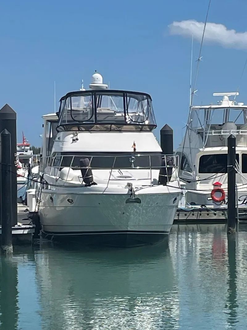 Slide: The Image of 2007 Meridian 459 Motoryacht docked in a marina under a clear blue sky. - 4