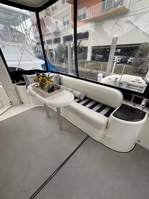 Slide: The Image of 2007 Meridian 459 Motoryacht interior with seating, table, and decorative flowers. - 9