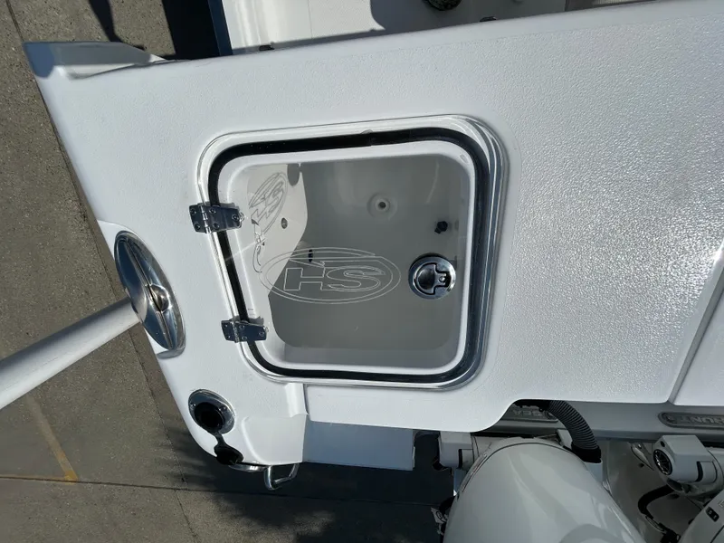 Slide: The Image of 2025 Sea Hunt Gamefish 25 boat compartment with open hatch, showcasing interior details. - 11