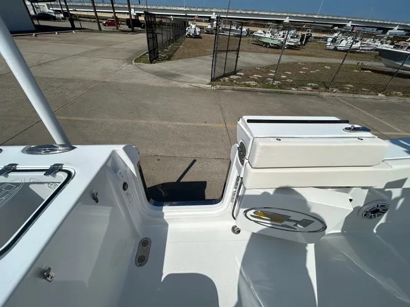 Slide: The Image of 2025 Sea Hunt Gamefish 25 boat interior, showcasing seating and deck details at a marina. - 12