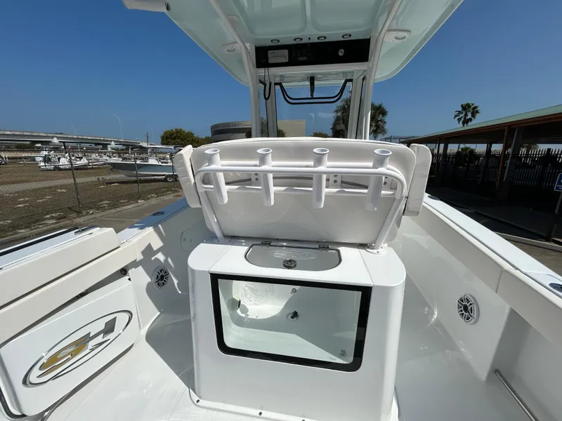 Slide: The Image of 2025 Sea Hunt Gamefish 25 boat interior with rod holders and storage compartment. - 13
