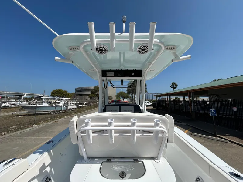 Slide: The Image of 2025 Sea Hunt Gamefish 25 boat, featuring a sleek design and modern amenities, docked under clear skies. - 15