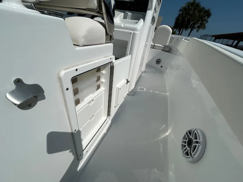 Slide: The Image of 2025 Sea Hunt Gamefish 25 boat interior with storage compartment and speaker. - 17