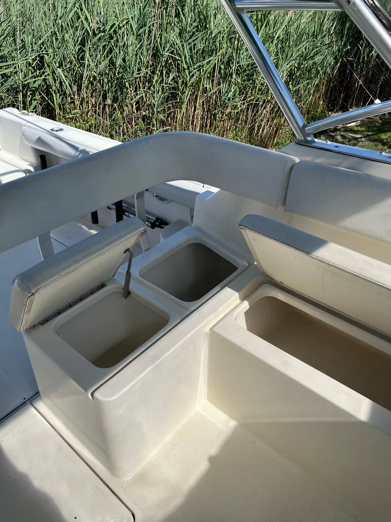 Slide: The Image of 2000 Pursuit 2860 Denali boat interior with open storage compartments. - 17