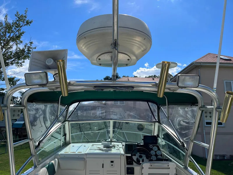 Slide: The Image of 2000 Pursuit 2860 Denali boat cockpit with radar and fishing rod holders. - 18