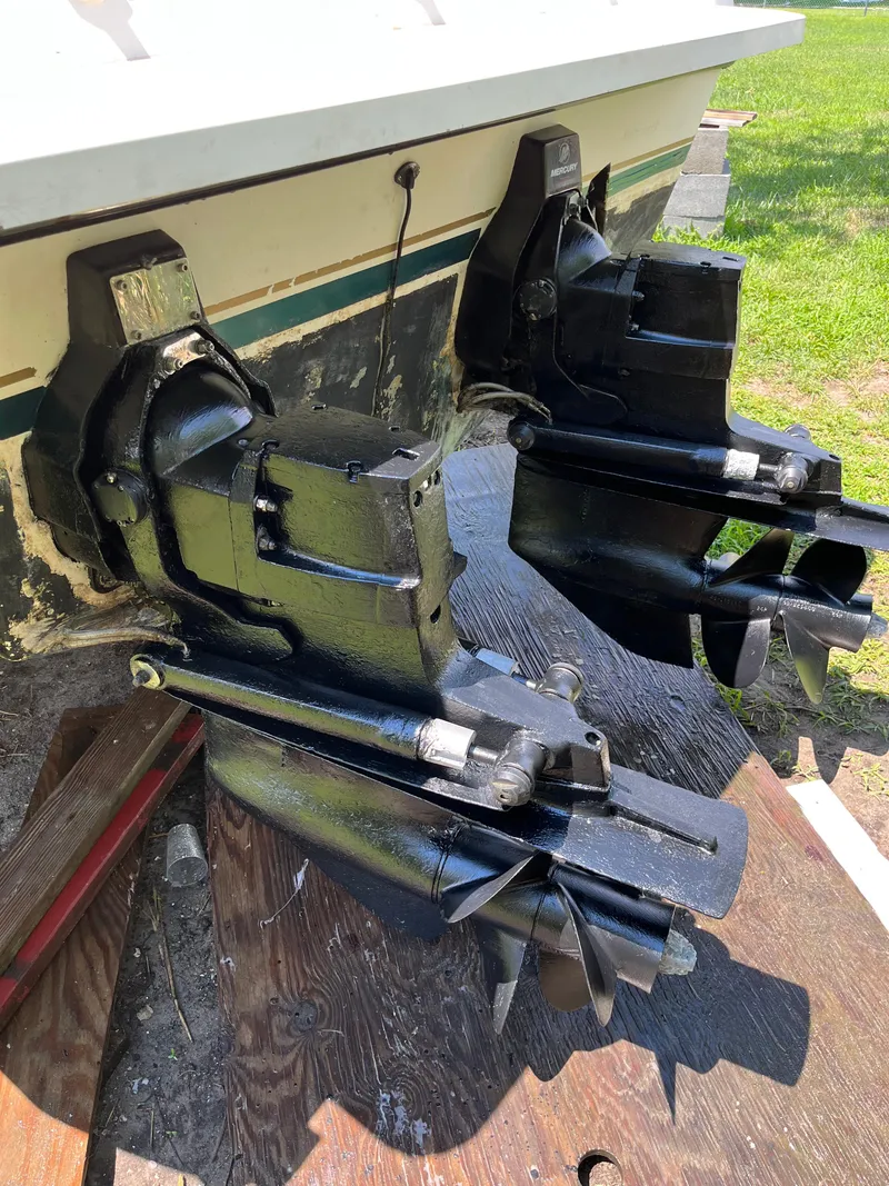 Slide: The Image of Twin outboard motors on a 2000 Pursuit 2860 Denali boat, displayed on a wooden platform. - 20