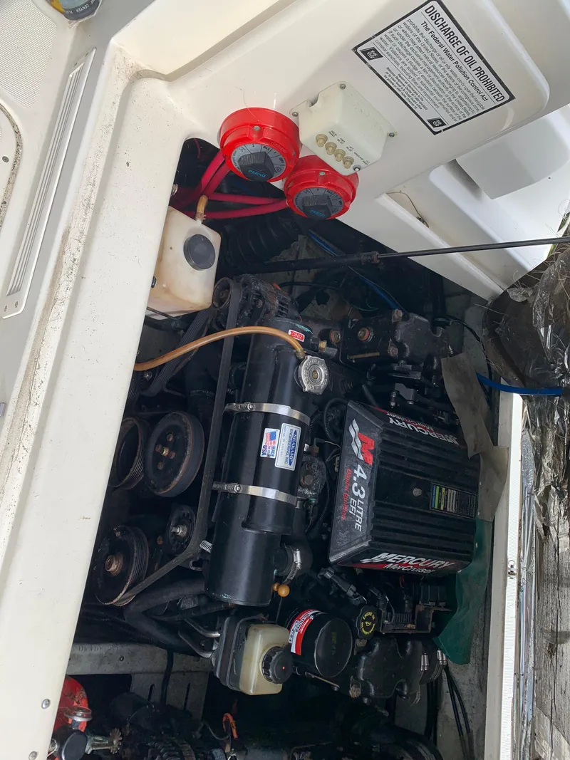 Slide: The Image of Engine compartment of a 2000 Pursuit 2860 Denali boat, showcasing mechanical components. - 21