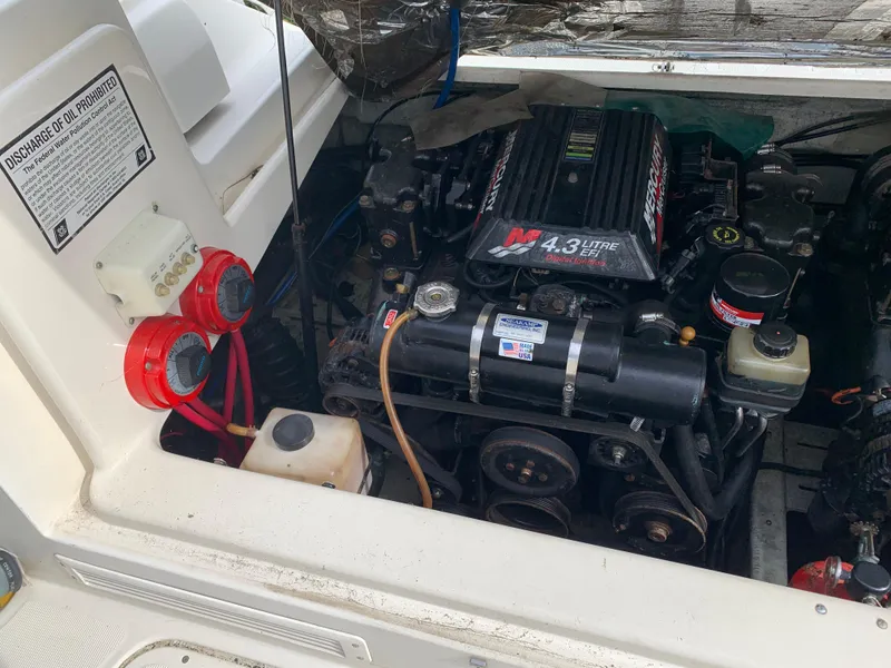 Slide: The Image of Engine compartment of a 2000 Pursuit 2860 Denali boat, featuring a 4.3L engine. - 22