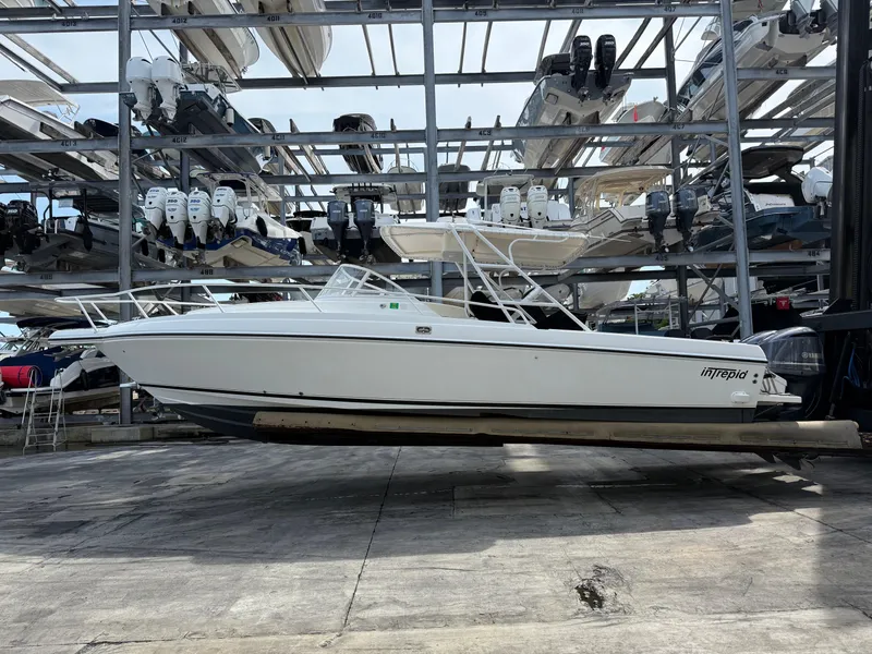 The Image of 1999 Intrepid 339 Walkaround boat with Yamaha 300 4-stroke engines in storage. - 1