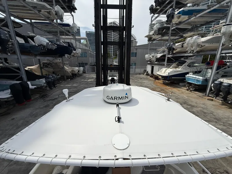 Slide: The Image of 1999 Intrepid 339 Walkaround boat with Garmin equipment in a marina storage area. - 11