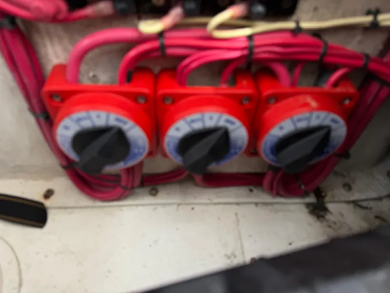 Slide: The Image of Red electrical switches with wiring on a 1999 Intrepid 339 Walkaround boat. - 20