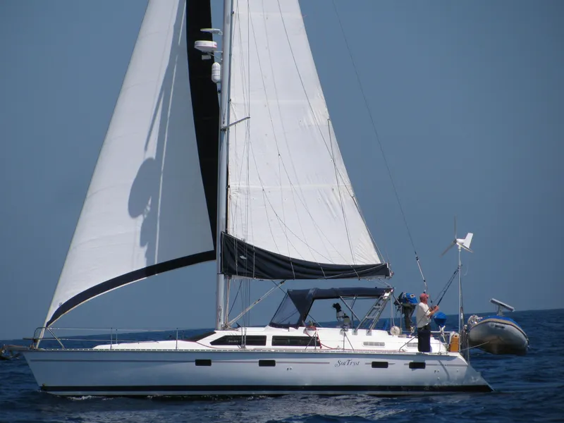 Slide: The Image of Sailing yacht Hunter Passage 42, 1993 model, cruising on open sea with full sails. - 0