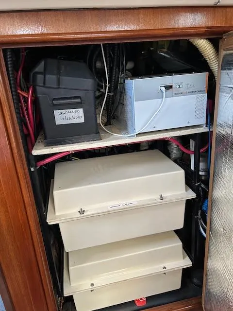 Slide: The Image of Electrical components inside a 1993 Hunter Passage 42 yacht, featuring wiring and battery systems. - 15