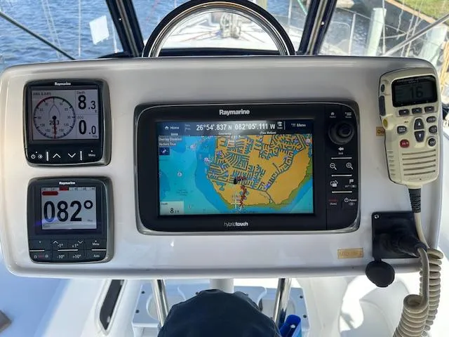 Slide: The Image of Navigation instruments on a 1993 Hunter Passage 42 sailboat, featuring Raymarine displays and a marine radio. - 17