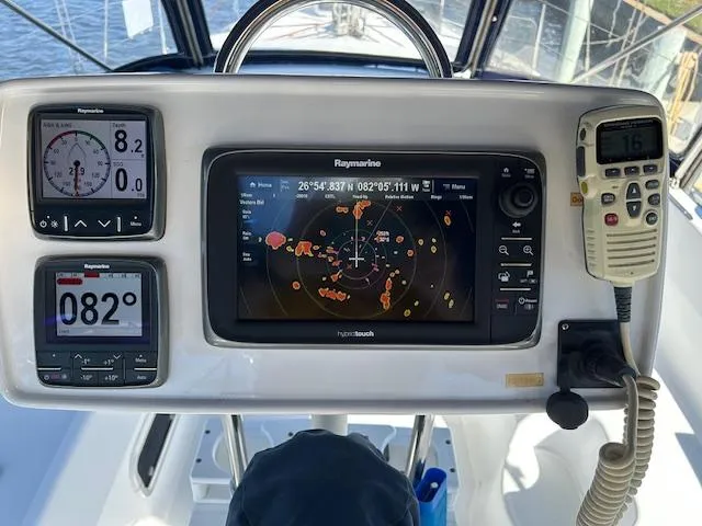 Slide: The Image of Cockpit navigation instruments on a 1993 Hunter Passage 42 sailboat, featuring Raymarine displays. - 18