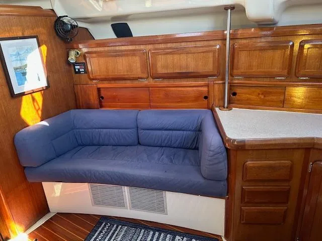 Slide: The Image of Interior of 1993 Hunter Passage 42 yacht with blue sofa and wooden cabinetry. - 3