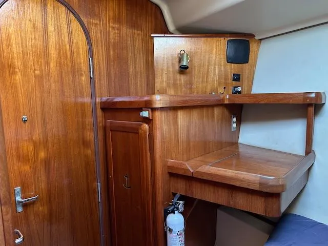 Slide: The Image of 1993 Hunter Passage 42 yacht interior with wooden cabinetry and desk area. - 7