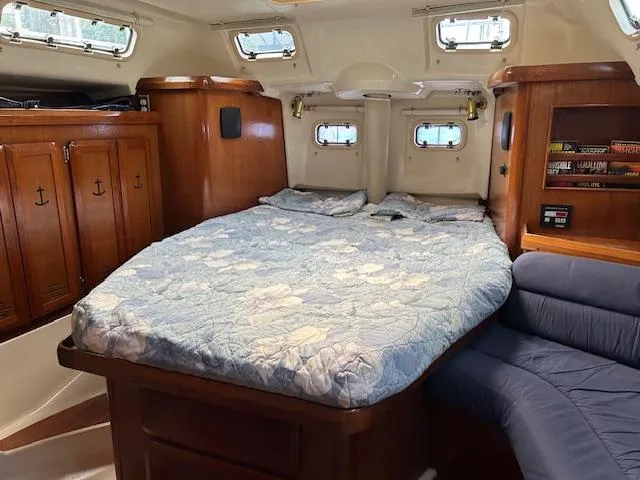 Slide: The Image of Cozy cabin interior of 1993 Hunter Passage 42 sailboat with bed and wooden cabinetry. - 8