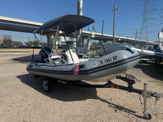 Slide: The Image of 2019 Zodiac Bayrunner 420 inflatable boat with canopy on a trailer. - 0