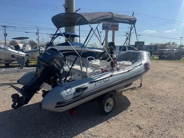 Slide: The Image of 2019 Zodiac Bayrunner 420 inflatable boat with outboard motor in a marina setting. - 3