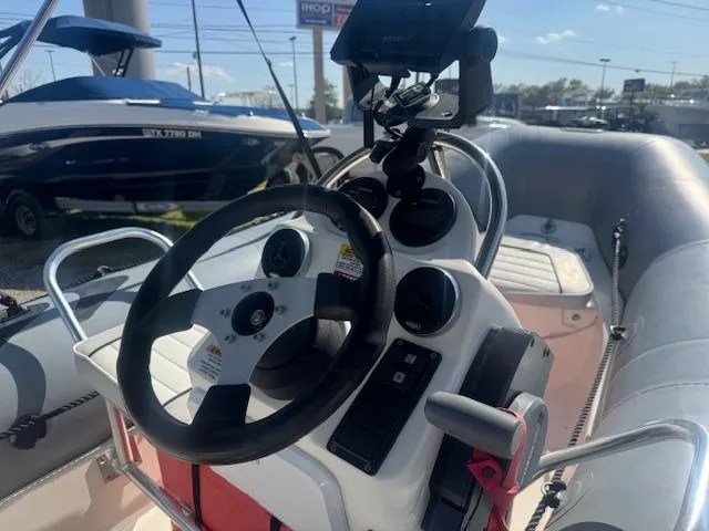 Slide: The Image of 2019 Zodiac Bayrunner 420 inflatable boat with canopy in a parking lot. - 7