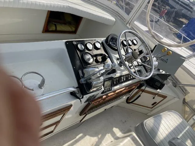 Slide: The Image of 1987 Blackfin 32 Flybridge helm with steering wheel and control panel. - 11