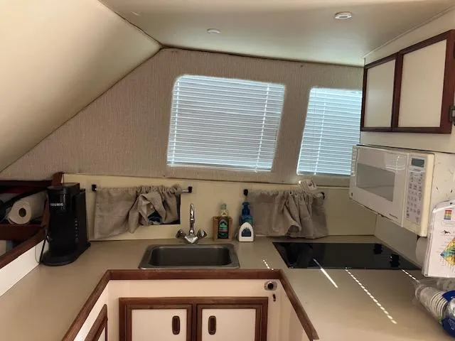 Slide: The Image of 1987 Blackfin 32 Flybridge kitchen with sink, microwave, and stove. - 15