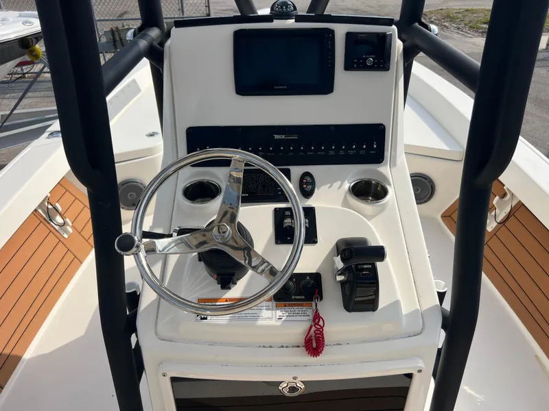 Slide: The Image of 2019 Pathfinder 2400 TRS boat console with steering wheel and navigation controls. - 10