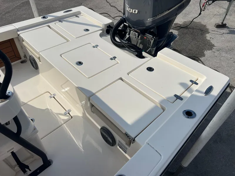 Slide: The Image of 2019 Pathfinder 2400 TRS boat deck with storage compartments and outboard motor. - 15