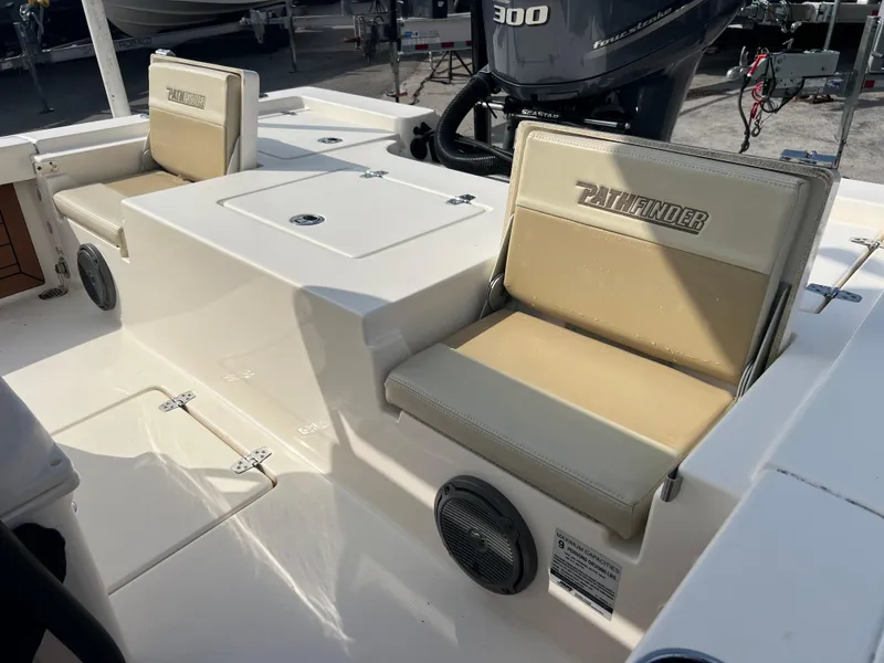 Slide: The Image of 2019 Pathfinder 2400 TRS boat interior with cushioned seats and powerful engine. - 16