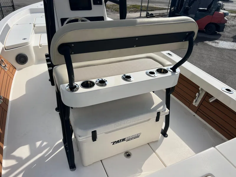 Slide: The Image of 2019 Pathfinder 2400 TRS boat interior with seating and storage cooler. - 8