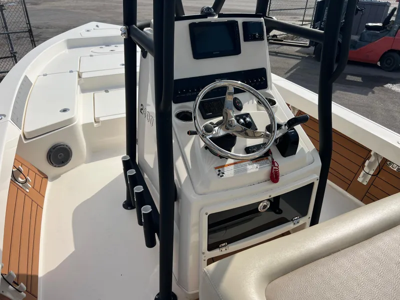 Slide: The Image of 2019 Pathfinder 2400 TRS boat console with steering wheel and navigation equipment. - 9