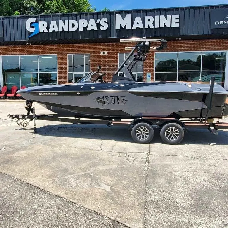 The Image of 2022 Axis Core Series A22 boat on trailer at Grandpa's Marine dealership. - 1