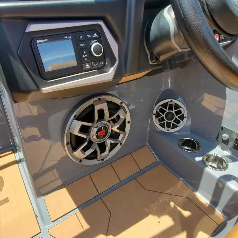 Slide: The Image of 2022 Axis Core Series A22 boat dashboard with speakers and control panel. - 10