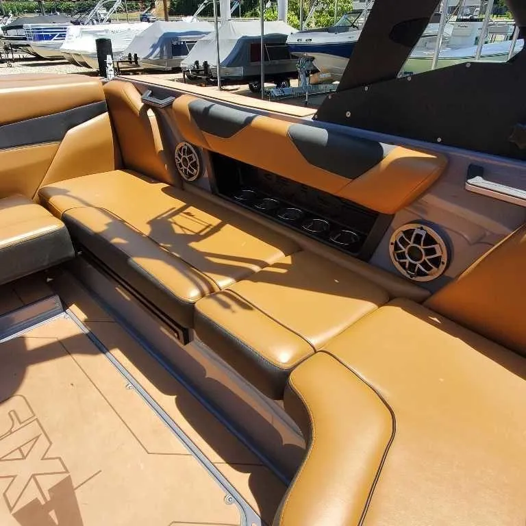Slide: The Image of 2022 Axis Core Series A22 boat interior with tan leather seating and built-in speakers. - 12