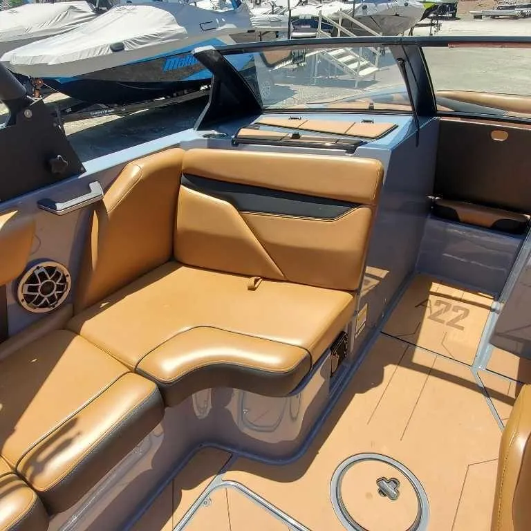 Slide: The Image of 2022 Axis Core Series A22 boat interior with tan seating and modern design. - 14