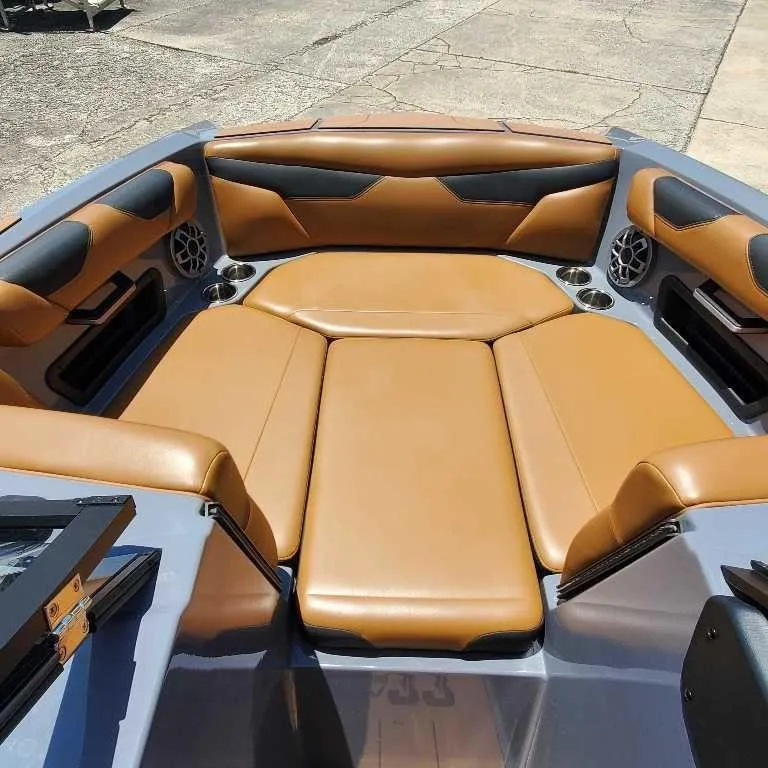 Slide: The Image of 2022 Axis Core Series A22 boat interior with tan and black seating. - 17