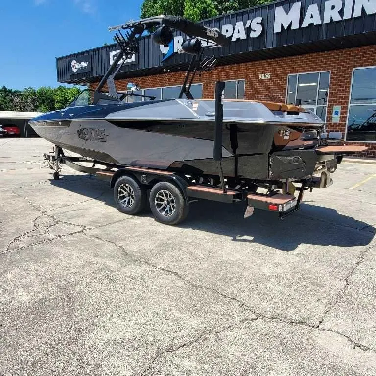 Slide: The Image of 2022 Axis Core Series A22 boat on trailer outside dealership. - 4