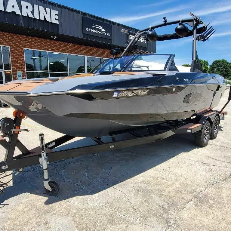 Slide: The Image of 2022 Axis Core Series A22 boat on trailer outside marine dealership. - 5