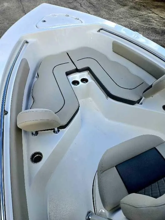 Slide: The Image of 2025 Key West 203 FS boat interior with cushioned seating and cup holders. - 14