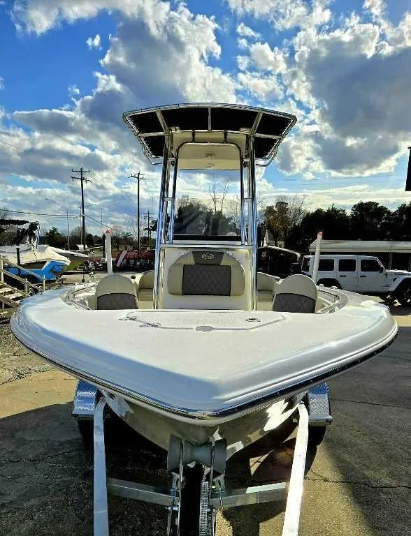 Slide: The Image of 2025 Key West 203 FS boat on trailer under a partly cloudy sky. - 3