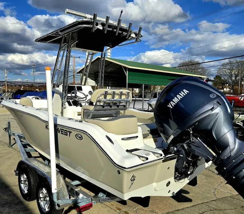 Slide: The Image of 2025 Key West 203 FS boat with Yamaha engine on trailer under cloudy sky. - 5