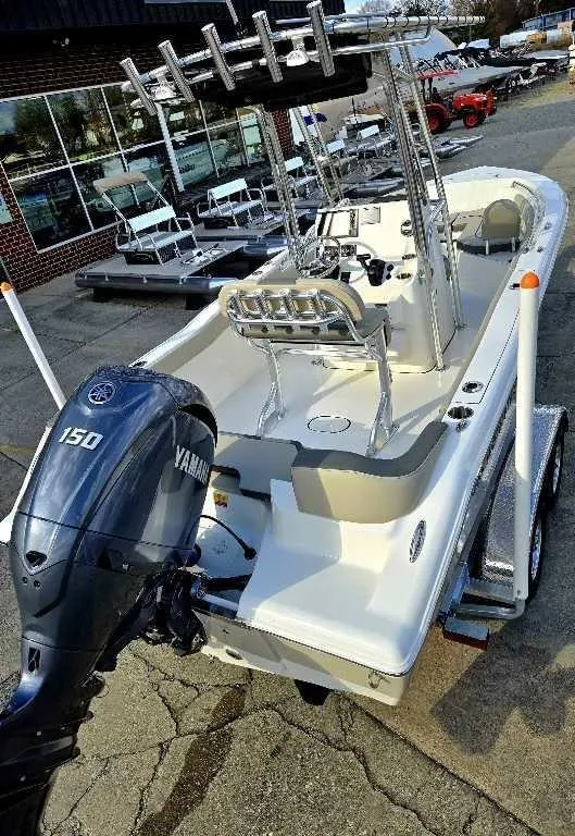 Slide: The Image of 2025 Key West 203 FS boat with Yamaha 150 engine on trailer, parked outdoors. - 8