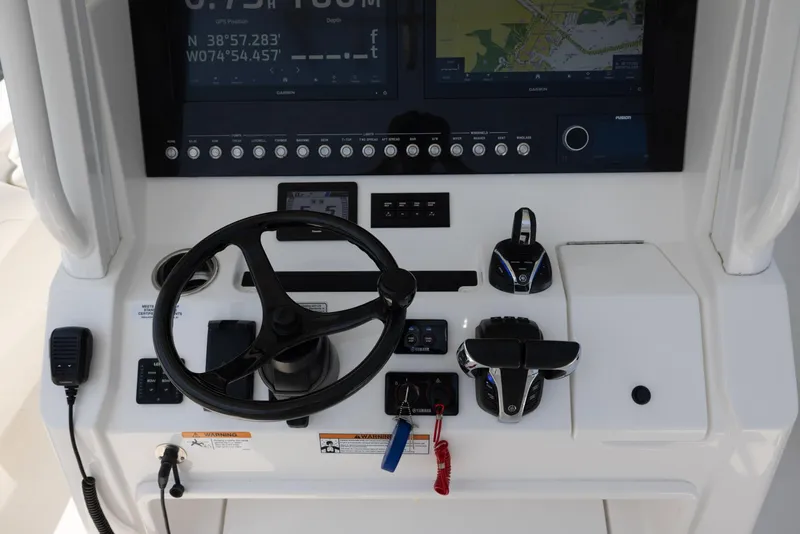 Slide: The Image of 2021 Regulator 28FS boat dashboard with navigation screens and controls. - 15
